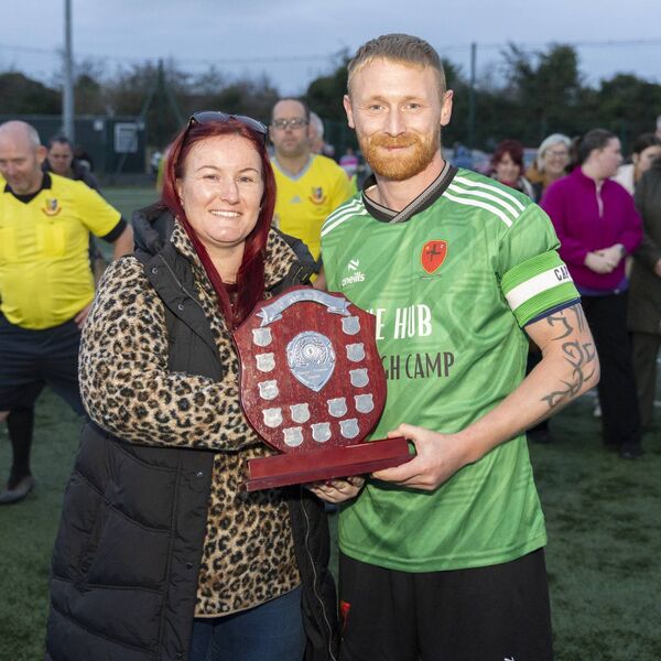Danielle Foley Hickey presents the Shield to Suncrofts Captain Shane Dillon 