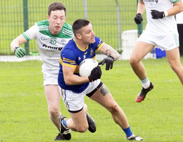 Grangenolvin's Timmy Doyle protects the ball from Cloughbawn's Aaron Byrne