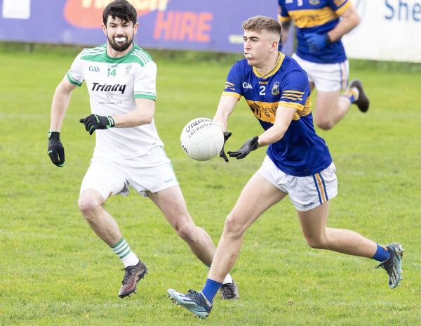 Grangenolvin's Gavin Ivory moves the ball out of defence with Connal Flood of Cloughbawn in close attendance