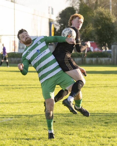 Chris Chanders tries to win possession for Clonmullion 
