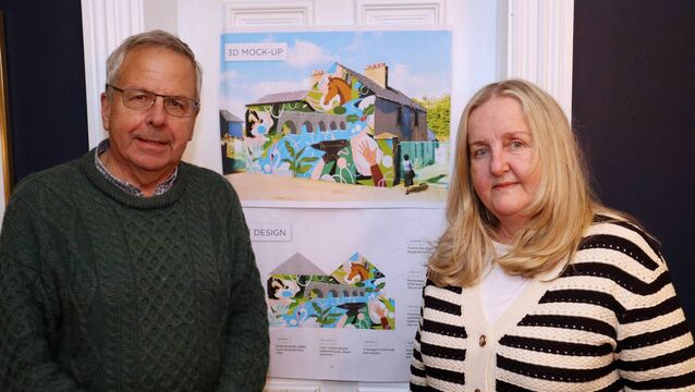 <p>KCA's Noel Clare and Anne Cashman with a draft representation of the Kilcullen Heritage Wall mural</p>