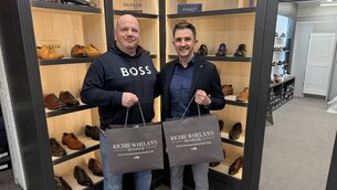 <p>Richie Whelan presents Ger McNally of the Kildare Nationalist with embroidered jumpers and jackets</p>