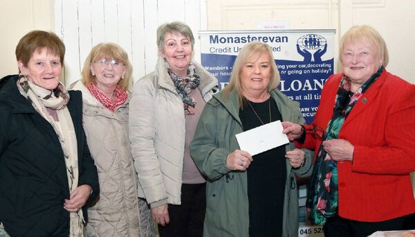 Man Beoga A ladies group who meet for crafts, workshops and outings accepting a cheque from Monastervan Credit Union's Mary Ryan 