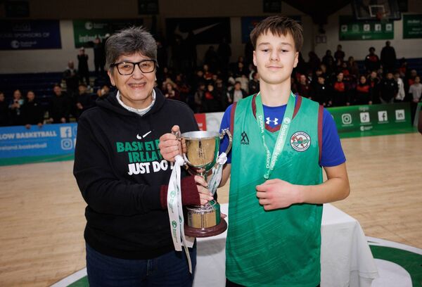 St. Conleth's captain Aleksandras Sulinskas is presented with the trophy by Basketball Ireland Head of International and Schools Operations Christine Connolly Photo: ©INPHO/Tom Maher St. Conleth's captain Aleksandras Sulinskas is presented with the trophy by Basketball Ireland Head of International and Schools Operations Christine Connolly Photo: ©INPHO/Tom Maher