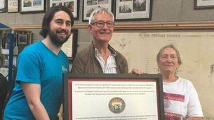 <p>Steven Connelly, chair of JuneFest, Mick Healy, and Linda Walker, a member of Friends of the International Brigades Ireland, with the Frank Conroy plaque</p>