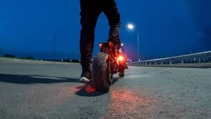 <p>back view of an electric scooter rider. evening road</p>