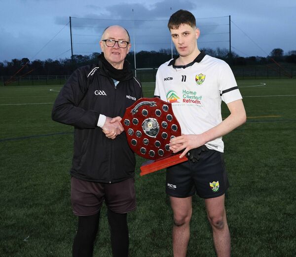 Liam Tolan presents Scoil Dara Kilock captain Bobby O'Shea with the South Leinster Schools 'C' SFC trophy after their defeat of Tullow CS 