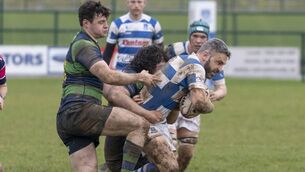 <p>Athy's influential scrum half, Eoin Farrell, is wrapped up by the Seapoint defenders.</p>