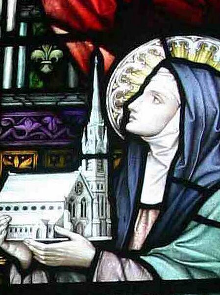 The stained glass image of Brigid commending the church to Jesus (the spire in the model was never built).