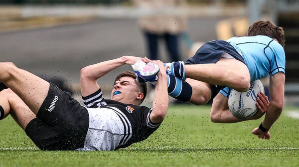 Newbridge's Aaron O'Donnell brillintly brings downs Gabriel Kelly (St Michaels). Photo: INPHO/Nick Elliott Newbridge's Aaron O'Donnell brillintly brings downs Gabriel Kelly (St Michaels). Photo: INPHO/Nick Elliott