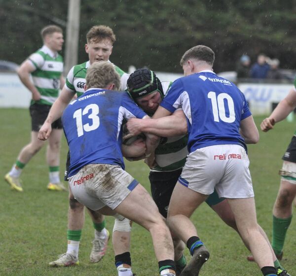 Stephen Lackey (Naas) has no way out as he is tackled by Queens duo Wilhelm De Klerk and Eamonn Rodgers. Stephen Lackey (Naas) has no way out as he is tackled by Queens duo Wilhelm De Klerk and Eamonn Rodgers.