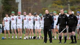 <p>The Kildare team stand for a minutes silence in honour of the Frisby family before the NHL Division 1B game against Derry. Photo: INPHO/Andrew Paton </p>