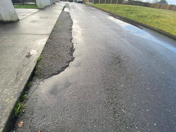 Uneven and unfinished road surfaces are a common feature outside residents' homes 