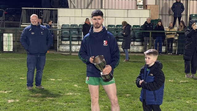 <p>Sarsfields captain Cian Byrne with the Aldridge Cup</p>