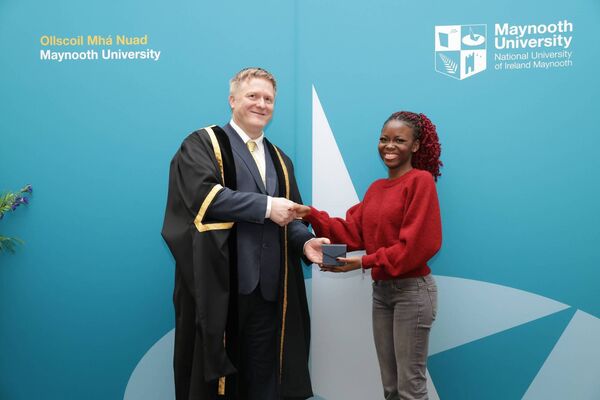ormer Maynooth Community College student Kehinde Oke receiving the scholarship