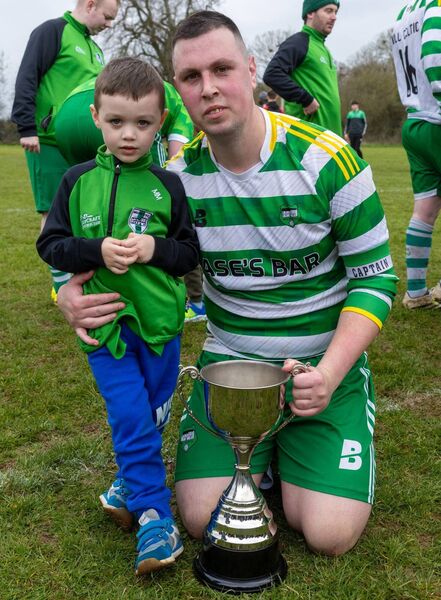 Brian Mackey, captain of Mill Celtic, with his son Mason and the Division 2 league trophy Photo: Michael O'Rourke