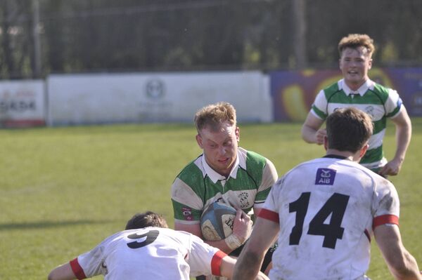 No way out for Darragh Murphy as the Naas flanker is tackled by Oscar Cawley and Alex Finlay. Photos: Martin Rowe.