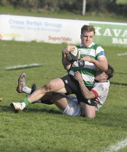 Charlie Sheridan charges in for a try despite the best efforts of DU's Jack O'Neill in the sunshine at Forenaughts on Saturday.