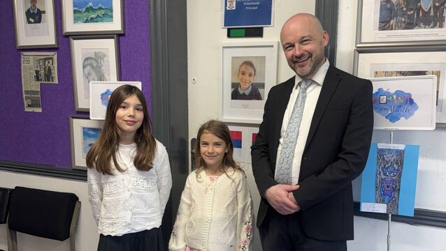 <p>Students Emilija and Julija Damjanovic with Patrician Primary School's principal David Dempsey</p>