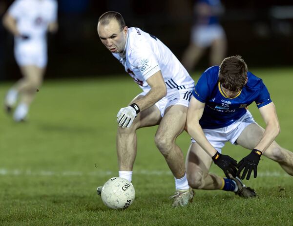 Kildare's Ben Ryan and Wicklow's Thomas Tisdall tussle for possession 