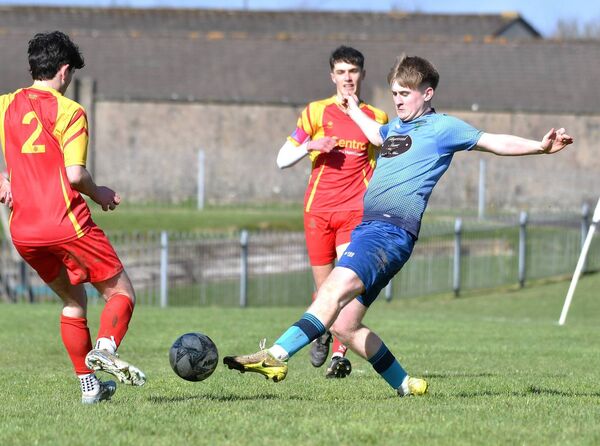 Rathangan's Darragh Cullen has his shot blocked down by Ballycane's Harry Jones.