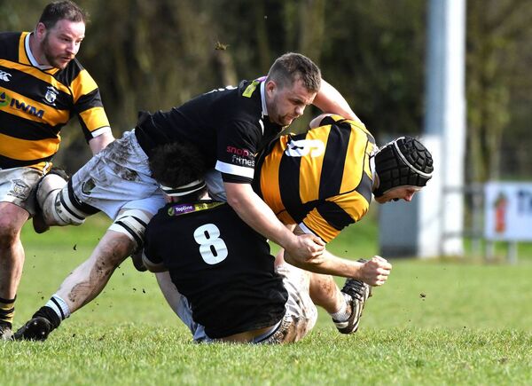 Newbridge's Mark Bennett is taken down by Longford's David Geelan and Seamus McKeon.