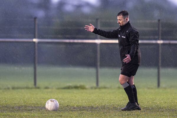 Referee Ian Howley inspects the pitch at half time Photo: James Lawlor