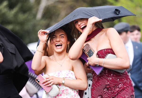  Racegoers brave the conditions 
