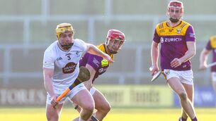 <p>Simon Leacy wins possession ahead of Wexford’s Lee Chin during the recent National League encounter at Wexford Park Photo: ©INPHO</p>