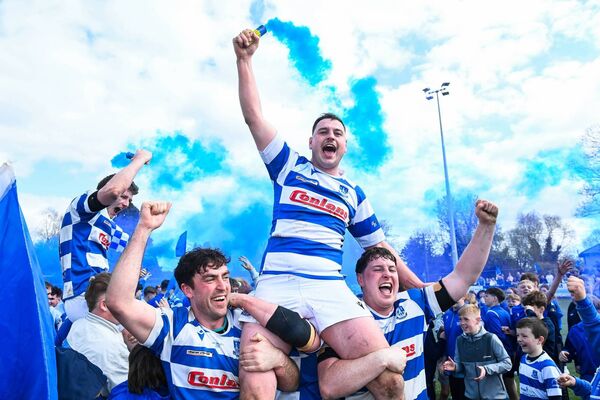Tom Sheedy is held aloft by Tom Brady and John Sheedy after the final.