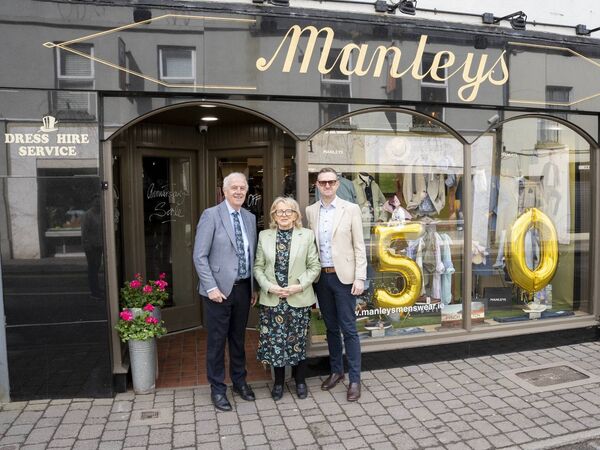 Tom, Susan and Philip Manley outside their shop