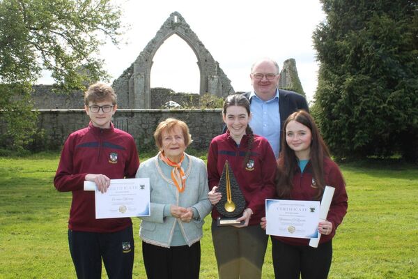 Cormac Murray, Nábla Kane, Jackie Dooley, Síanainn O'Rourke and Emmet Kane pictured in front of Castledermot Abbey, beside the school