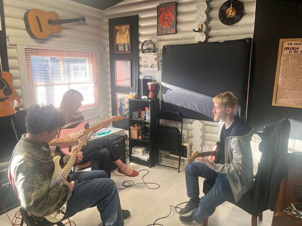 Students Aaron and April Lawlor having their electric guitar lesson with Neil Neil Foley Students Aaron and April Lawlor having their electric guitar lesson with Neil Neil Foley
