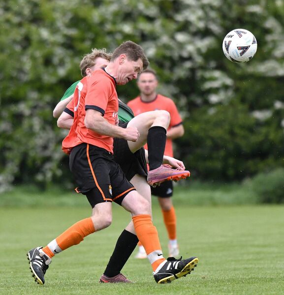 Alan Campbell heads clear for Caragh Celtic