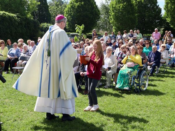 Bishop Nulty accepts a baby oak tree to be planted later in the school grounds.