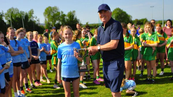 Allenwood's Holly Carpenter receives the Cumann na mBunscol Division 5 Football title. Allenwood's Holly Carpenter receives the Cumann na mBunscol Division 5 Football title.