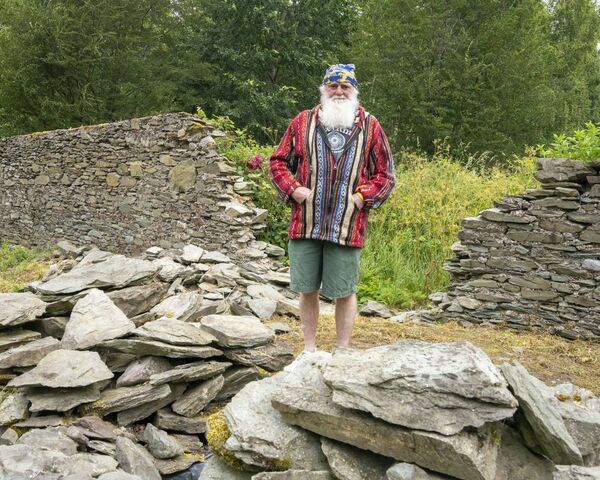 Stone mason Seamus Fahey who is repairing the wall in the Graveyard Stone mason Seamus Fahey who is repairing the wall in the Graveyard
