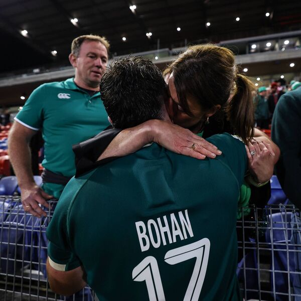 Billy Bohan celebrates after the game with a hug from his mother Amanda, while father Enda watches on  