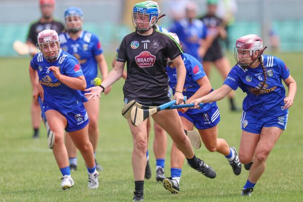 Caoimhe Ní Bhuircéal gets the ball away for Kildare with an army of Cavan players giving chase. Caoimhe Ní Bhuircéal gets the ball away for Kildare with an army of Cavan players giving chase.