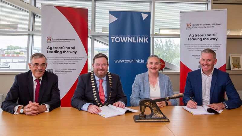 image of contractor and local authority staff sitting at desk for contract signing