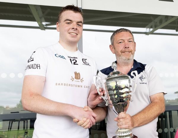 Clane captain Cormac Vizzard receives the Division 2 trophy from Dave Cahill (Kildare GAA) Photo: Sean Brilly