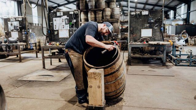 <p>Head cooper Ian Leonard works on one of the Irish oak casks to prepare for the head fitting at Newbridge's Kentucky Bourbon Barrel. Picture: Brian Connolly/Bang Bang Visual. </p>