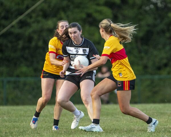 Kilcullen's Ellie O'Toole is stopped in her tracks by St Laurences Wheeler sisters, Gillian and Ciara. Photo: Aisling Hyland Kilcullen's Ellie O'Toole is stopped in her tracks by St Laurences Wheeler sisters, Gillian and Ciara. Photo: Aisling Hyland