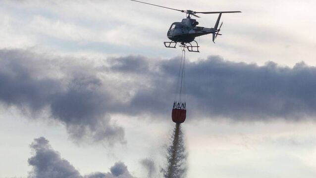 <p>Helicopter and Bambi bucket putting out the fire at the Rathconnell bog</p>