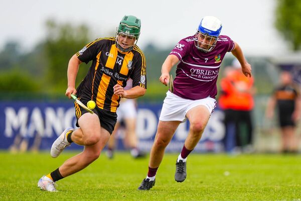 Round Towes' hat-trick hero Robbie Byrne on his way to scoring a goal, with Athy's James Keegan giving chase. Round Towes' hat-trick hero Robbie Byrne on his way to scoring a goal, with Athy's James Keegan giving chase.