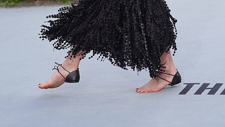 Margaret Qualley walks white carpet in barefoot Chanel sandals