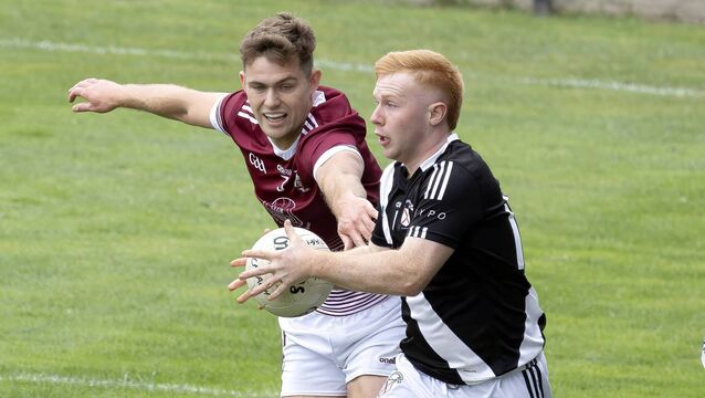 <p>Caragh's Paul Dockery closes down Maynooth's Paddy Mahoney. Photo: Sean Brilly.</p>