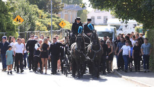 <p>The coffin of Jimmy O’Brien leaving the Church of the Holy Family in Askea, Carlow, followed by family and mourners.</p>