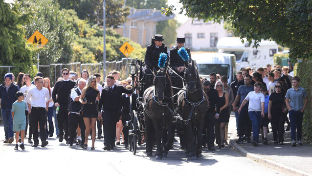 <p>The coffin of Jimmy O’Brien leaving the Church of the Holy Family in Askea, Carlow, followed by family and mourners.</p>