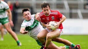 <p>Niall Kelly (Athy) tries to hold off the challenge from Sallins defender Paul Farrelly Photo: James Lawlor </p>